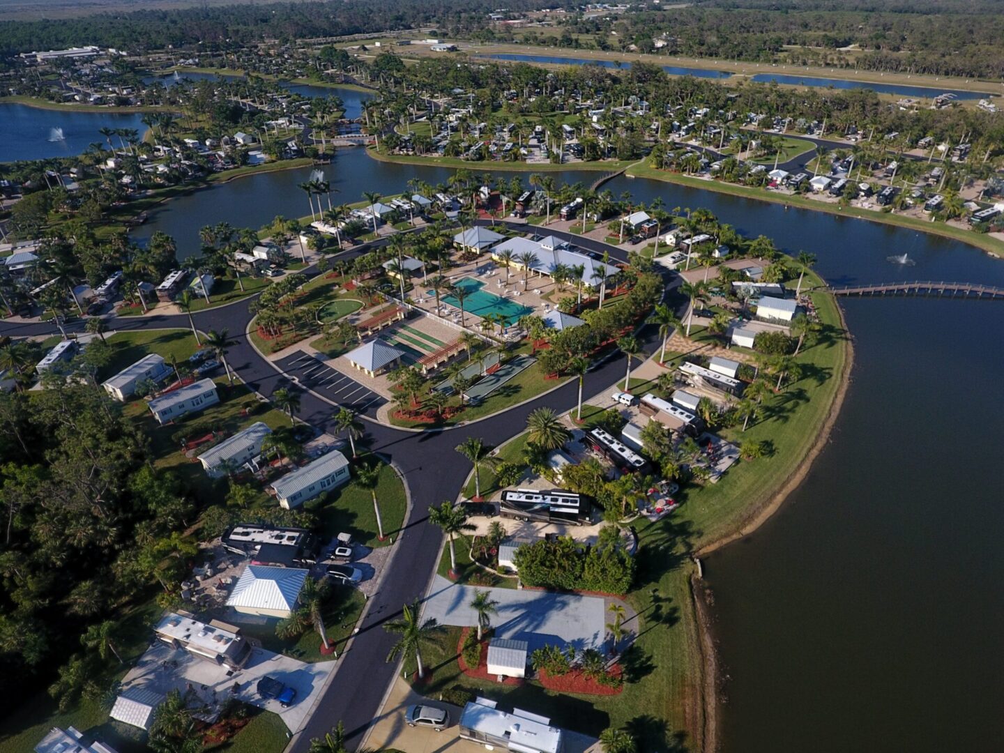 Aerial view of a residential community with water features and houses. Aerial view of a residential community with water features and houses.