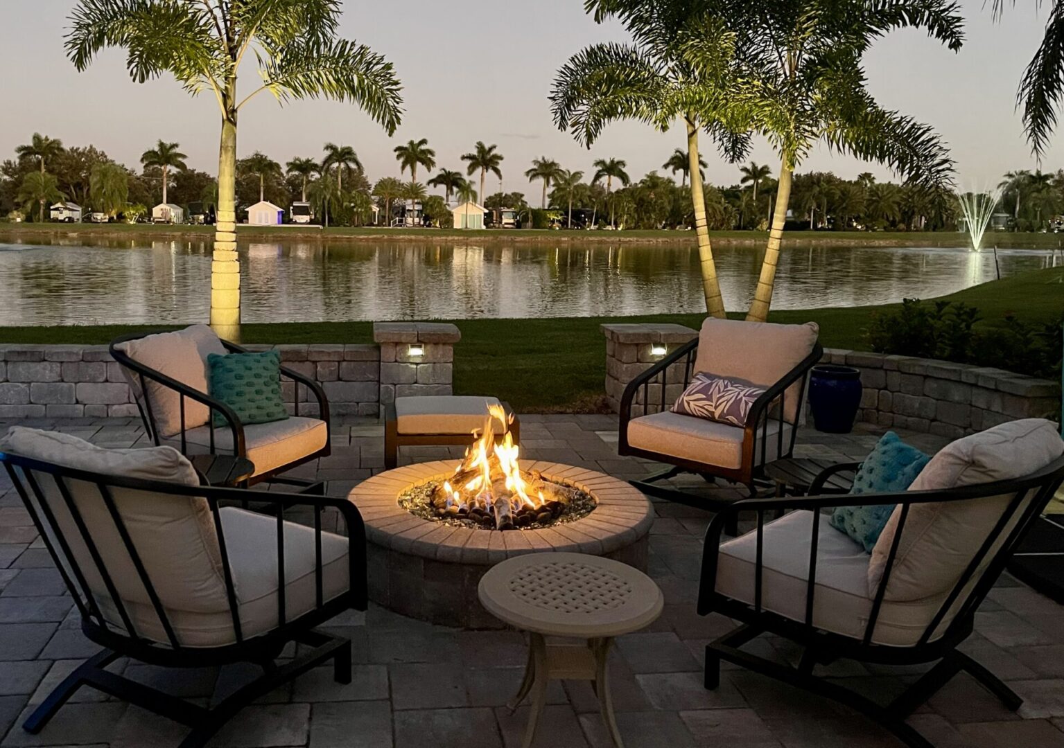 Cozy outdoor seating around a fire pit near a tranquil lake at sunset. Cozy outdoor seating around a fire pit near a tranquil lake at sunset.