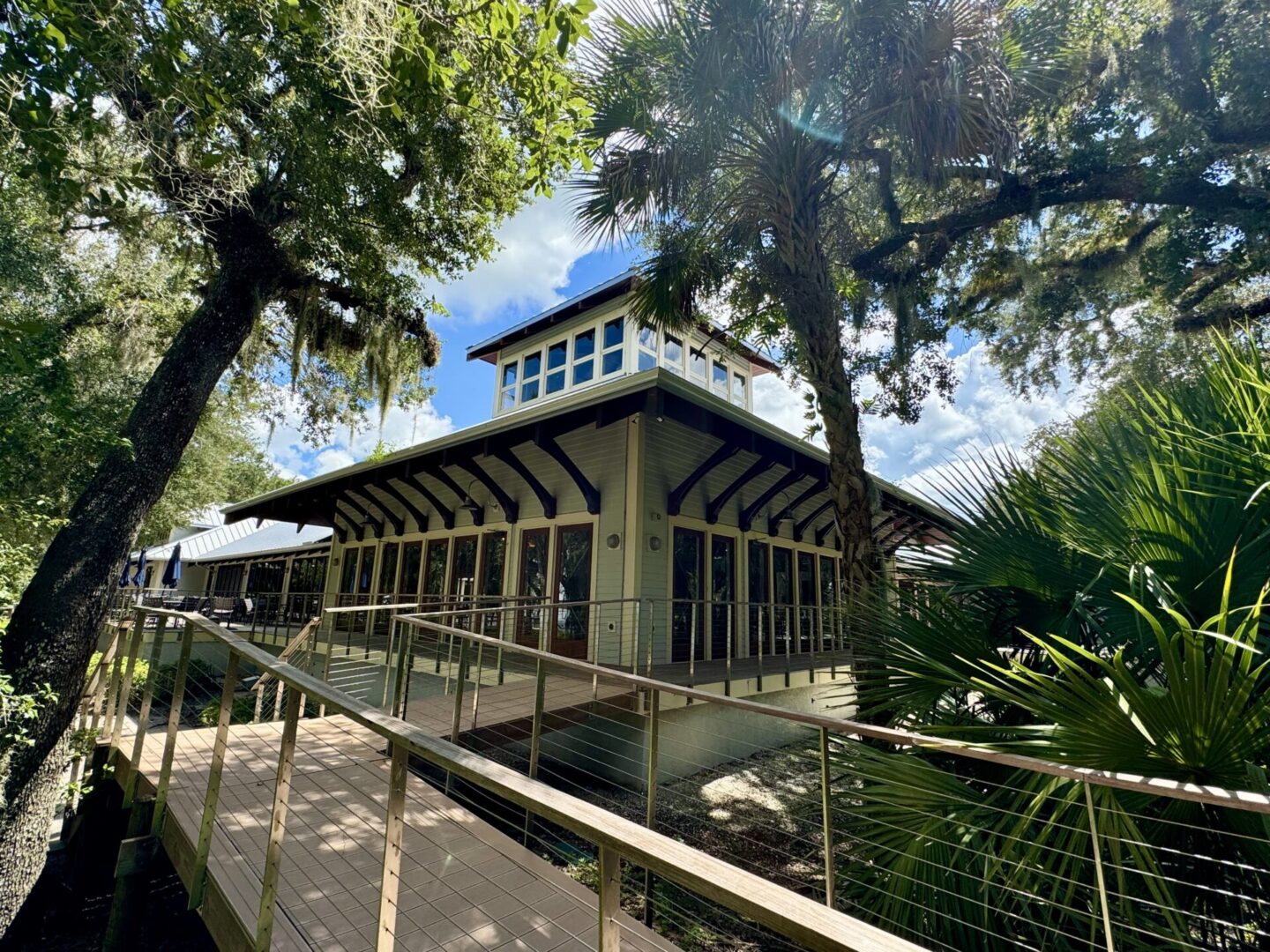 A rustic elevated wooden house surrounded by lush greenery on a sunny day. A rustic elevated wooden house surrounded by lush greenery on a sunny day.